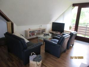 a living room with two chairs and a television at Ferienwohnung,Über Tage in Bochum