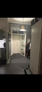 a room with a hallway with a door and a light at Superfin lägenhet 2 rok Söderfors wärdshus in Söderfors