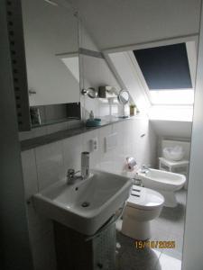 a bathroom with a sink and a toilet at Ferienwohnung,Über Tage in Bochum +12 photos