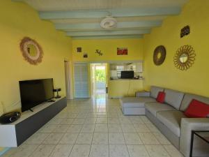 a living room with a couch and a tv at Seru Coral Resort Appartement 188 in Willemstad