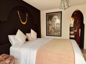 a bedroom with a bed and a picture on the wall at Riad SASHA Exclusive&New Pool 6 pax Free Breakfast in Marrakech +47 photos