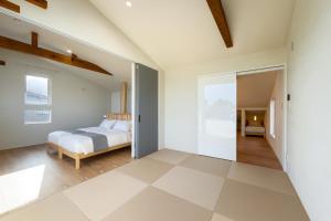 a bedroom with a bed in a room at The Lobs Toya, Chalet Secca in Lake Toya