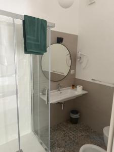 a bathroom with a shower and a sink and a mirror at Dimora del Salento Apartment in Brindisi