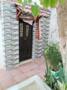 a door of a house with a red scarf on it at Casa Del Amor in Al Karm