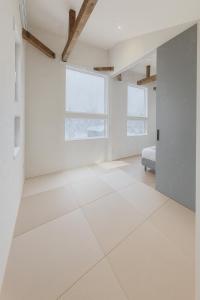 an empty room with white walls and a door at The Lobs Toya, Chalet Secca in Lake Toya +20 photos