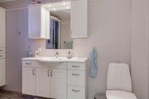 a bathroom with a sink and a toilet and a mirror at Lindgren Land in Vimmerby +37 photos