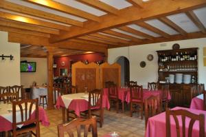 a restaurant with tables and chairs in a room at Casa Polín in Las Herrerías