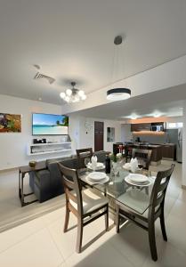 a dining room and living room with a table and chairs at Casa Buddha - Pool, Jacuzzi and private terrace in Cancún