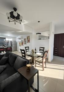 a living room with a couch and a table at Casa Buddha - Pool, Jacuzzi and private terrace in Cancún