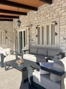 a living room with a couch and a table at Villa Mali Raj in Žikovići +19 photos