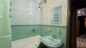 a bathroom with a sink and a tub and a toilet at MOK Apartment in Samarkand +10 photos