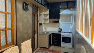 a small kitchen with a sink and a stove at MOK Apartment in Samarkand