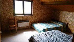a bedroom with two beds and a window at Chalet Mouthe 6 personnes in Mouthe