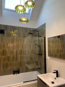 a bathroom with a shower and a sink at High Shilford Barn in Ridingmill +46 photos