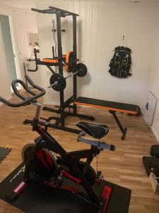 a gym with several exercise bikes in a room at 1 roms kjellerleilighet Norheim, Haugesund in Karmøy