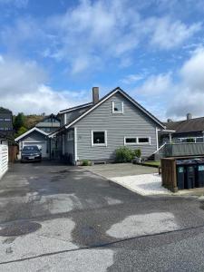 a house with a car parked in a driveway at 1 roms kjellerleilighet Norheim, Haugesund in Karmøy +8 photos