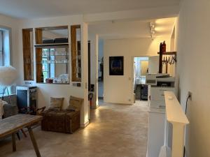 a kitchen and living room with a table and a couch at Alte Poststation in Quedlinburg