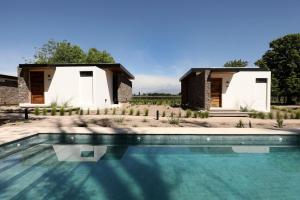 una casa con piscina delante en Boutique Hotel Bodega CICLO ANDINO, en Perdriel