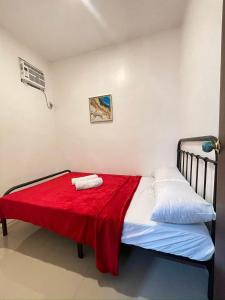 a bedroom with a bed with a red blanket at J&L Apartment 