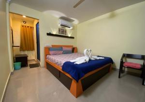 a bedroom with a bed with a blue blanket at Joys Stay in Trichūr
