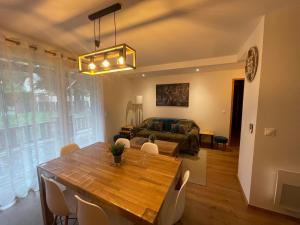 a living room with a table and a couch at Appartement Résidence Les Lauzes in Vielle-Aure