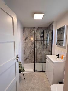 a bathroom with a shower and a toilet and a sink at Little Wren Cartmel Couples Retreat in Cartmel +20 photos