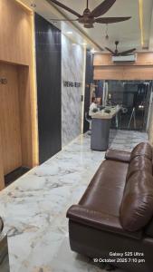 a bar with a leather couch sitting on a counter at krishna residency in Mathura