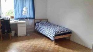 a bedroom with a bed and a desk and a window at Beautiful apartment in Dornach in Dornach