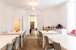 a dining room with white tables and chairs at Château de Seurre in Seurre +37 photos