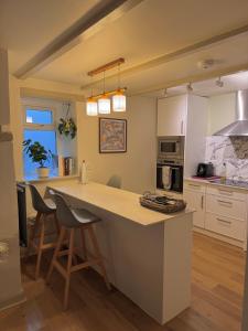 a kitchen with a large island in the middle at Little Wren Cartmel Couples Retreat in Cartmel