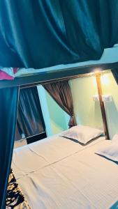 a top bunk bed in a blue tent at REST POINT Dormitory in Jaipur