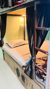 an upper bunk of a bed in a room at REST POINT Dormitory in Jaipur