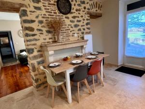 a dining room with a wooden table and chairs at La Maisonnette de Chevannes in Sainte-Magnance