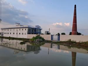 a building next to a body of water at VnM Paradise in Chunār