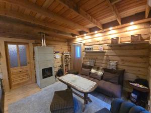 a living room with a couch and a fireplace at Tammetalu puhkemaja 