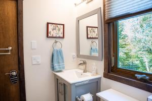 a bathroom with a sink and a mirror at Blue Haven home in Killington Village +32 photos