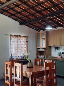 a kitchen with a wooden table with chairs and a dining room at Sitio Damiana in Paracuru