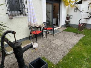 a patio with two chairs and a table and an umbrella at Komfortzimmer in Trieben