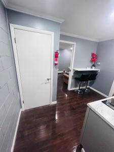 a kitchen with a white door and a desk at My lil doll house in Elizabeth +5 photos