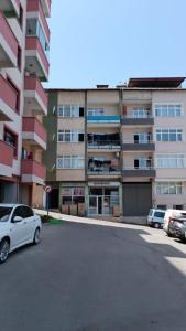 a white car parked in front of a building at İsmail Yılmaz Hotel in Trabzon