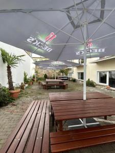 two wooden benches sitting under an umbrella on a patio at Residence Amira in Hannover
