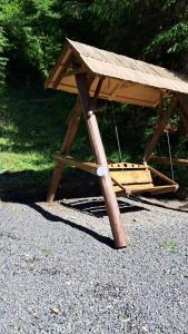 a wooden picnic table sitting on the ground at Гірська роса in Synevyrsʼka Polyana