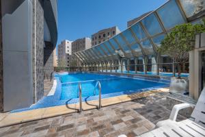 a swimming pool in the middle of a building at Wahaj Hotel Apartments 2 in Kuwait