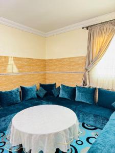 a blue couch with a white table in a room at Cozy & Chic Agadir Netflix, Beach & Comfort in Agadir