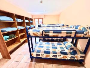 a room with three bunk beds in a room at Albergue Urbasa in Eulate