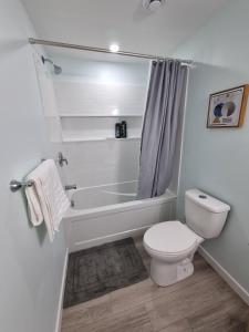 Un baño con bañera, inodoro y ducha. en Kelvista's suite, en Winnipeg 10 fotos más