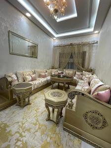 a living room with couches and tables in a room at Appartement de 3 chambres, Tanger NAKHIL BOUGHAZ 2 in Tangier