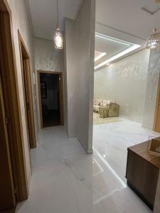 a living room with white tile floors and a hallway at Appartement de 3 chambres, Tanger NAKHIL BOUGHAZ 2 in Tangier +14 photos