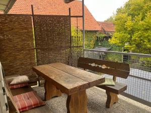 a wooden table and bench on a balcony at Fachwerkzauber Eggenbach in Ebensfeld