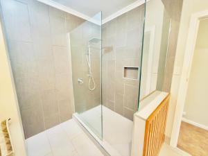 a shower with a glass door in a bathroom at Lakeside Haven - Park the Boat, Relax and Unwind in Mulwala +16 photos